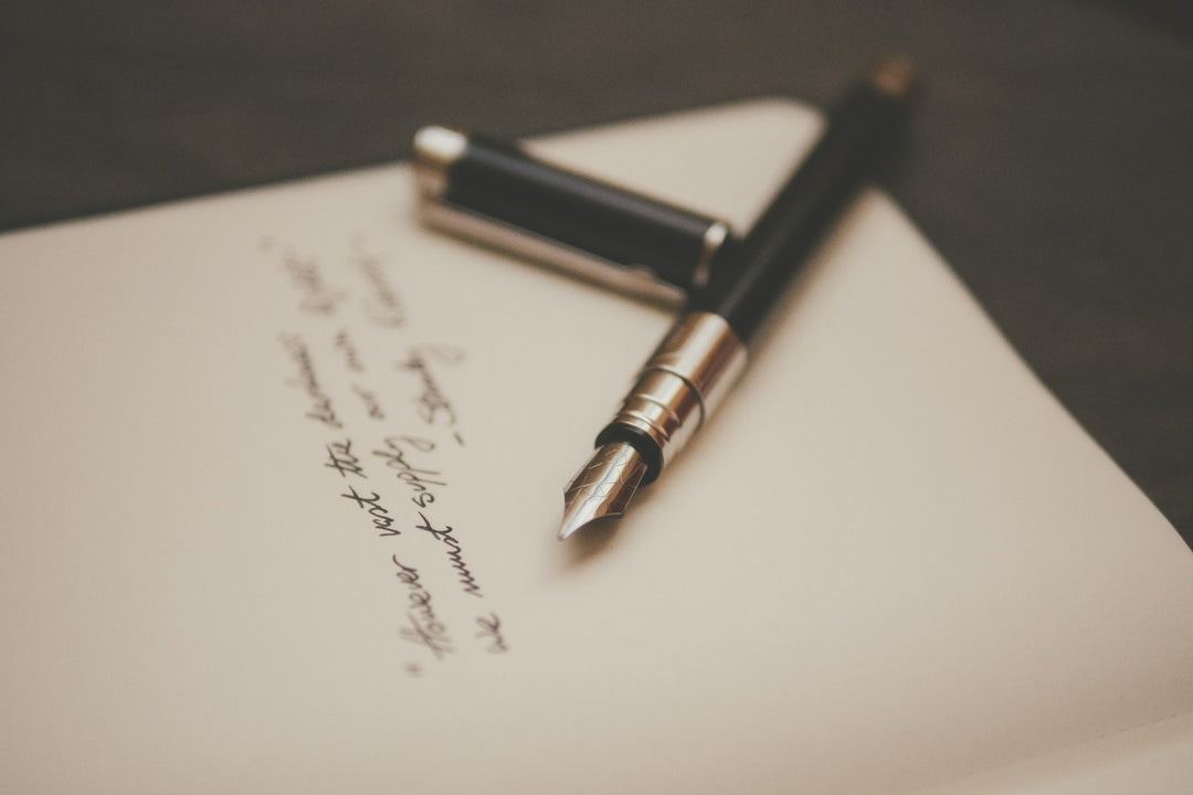 A fountain pen resting on a handwritten letter