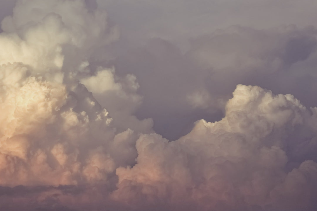 Dramatic clouds lit warm at sunset