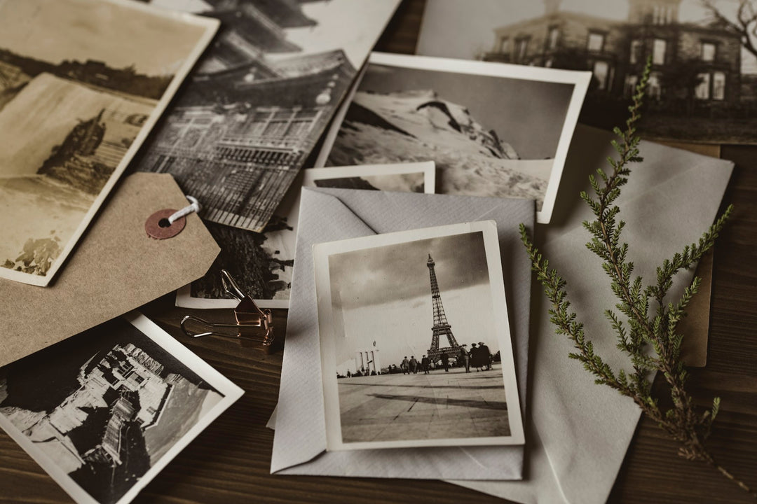 Vintage black and white travel photographs spread on a table
