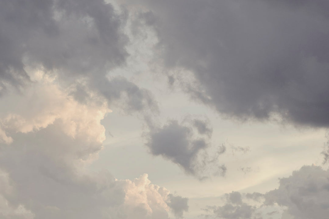 Soft storm clouds tinged with violet light