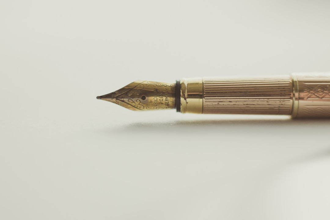 A fountain pen on a plain cream background