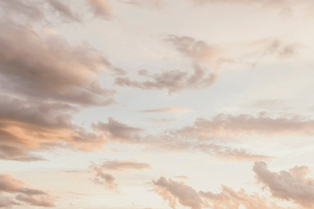 Warm sunset clouds in shades of peach and lavender