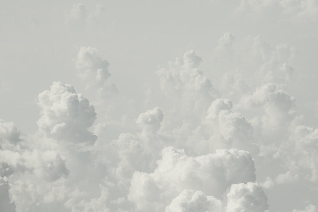 Soft white clouds in a pale sky