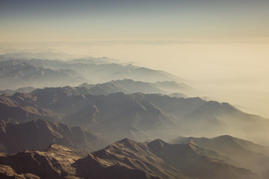 Golden mist settling over mountain ridges