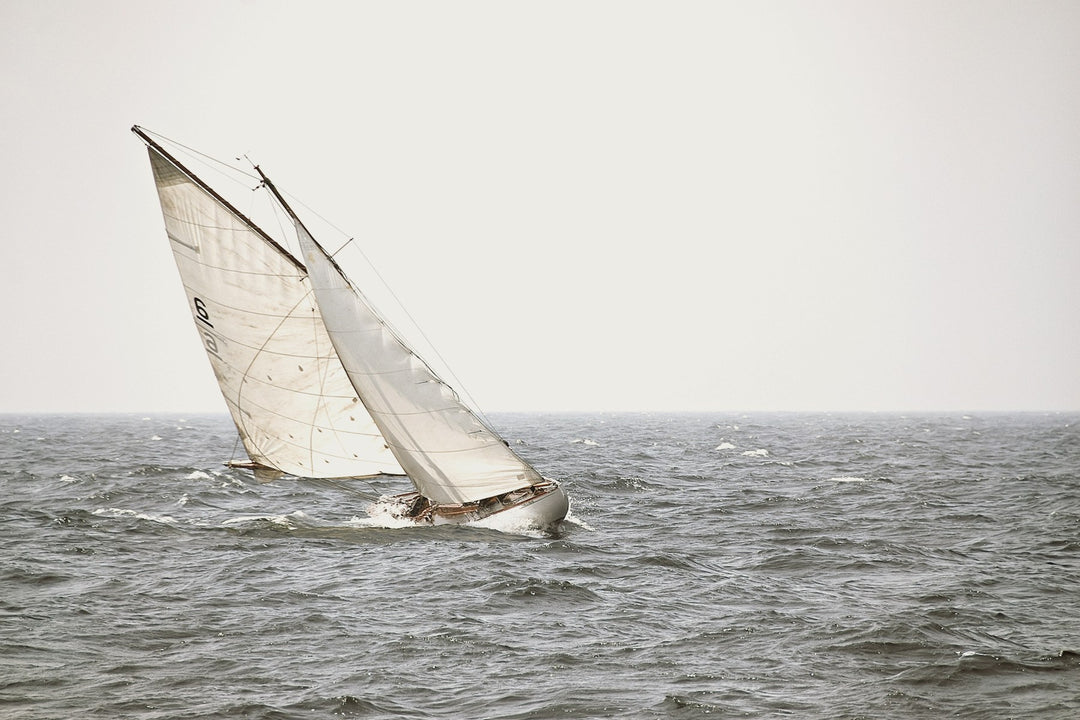A classic sailboat heeling in the wind