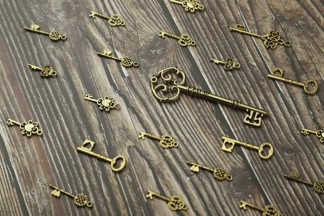 Antique brass keys scattered on weathered wood