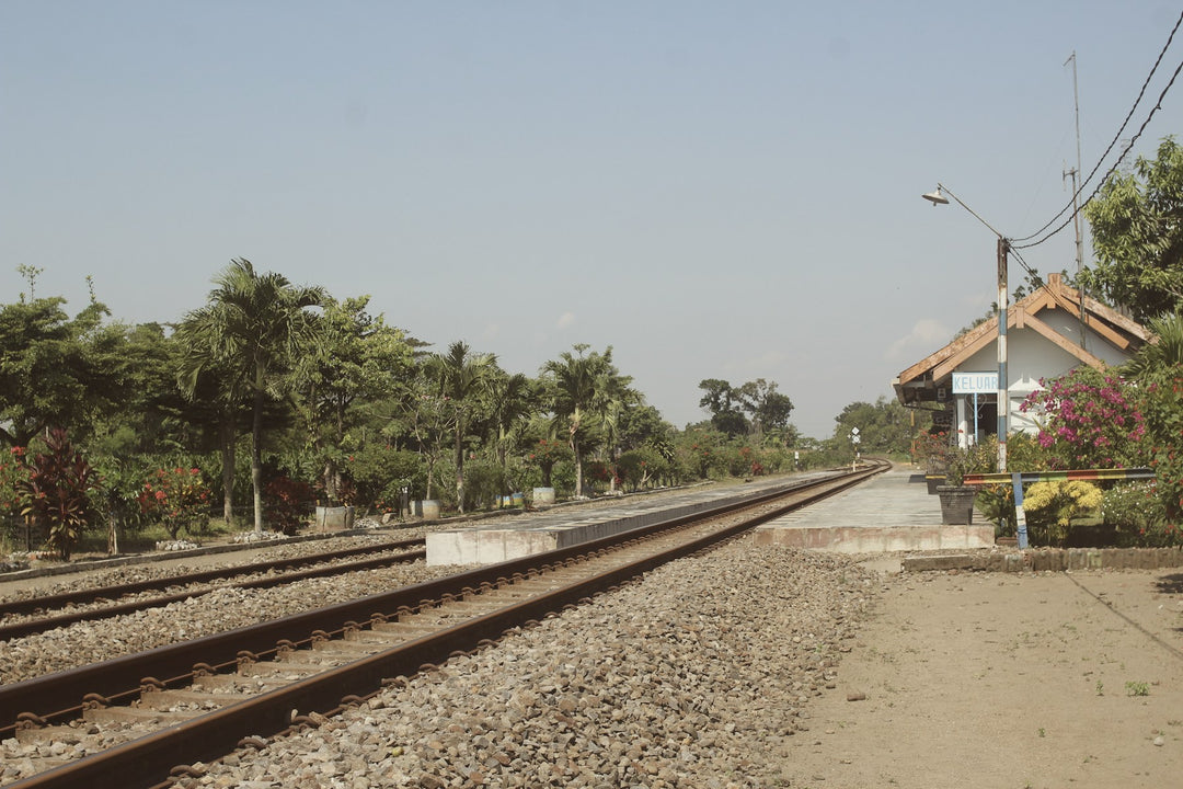 Railway tracks running past an old country station