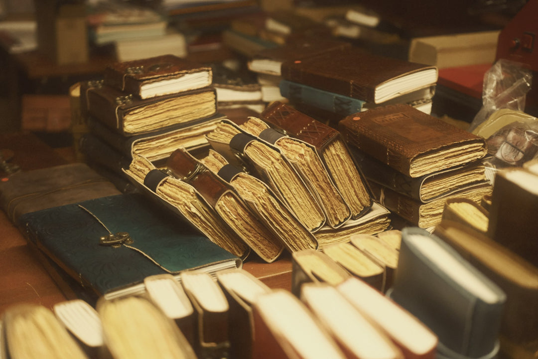 Stacks of old books in warm light