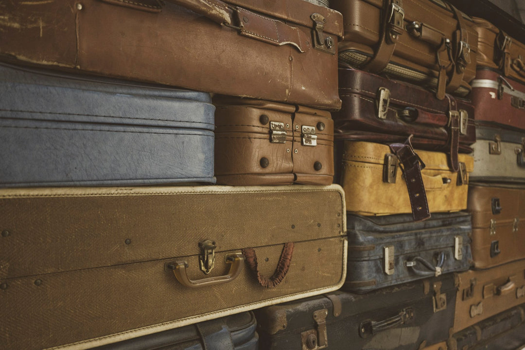 A stack of worn vintage suitcases