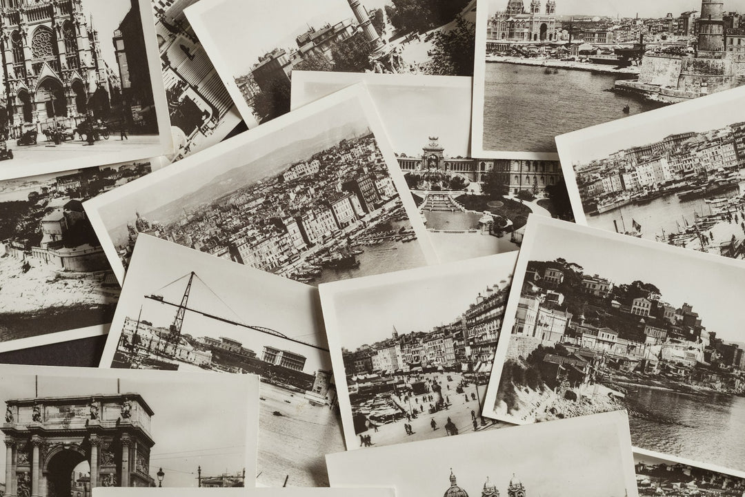 A pile of vintage black and white postcards